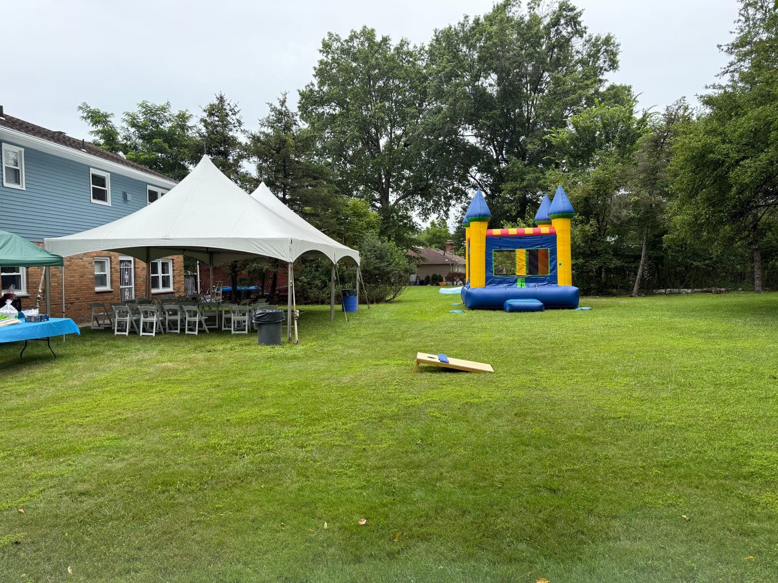 20x30 frame tent setup with round tables and padded chairs for a New Jersey backyard wedding